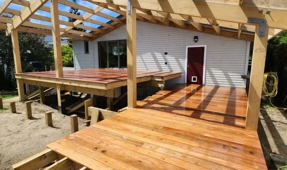 Deck Builders Levin team from Builders Levin discussing full-service project plans on-site